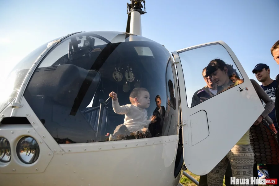 Дети выстроились в очередь, чтобы посидеть в вертолете.